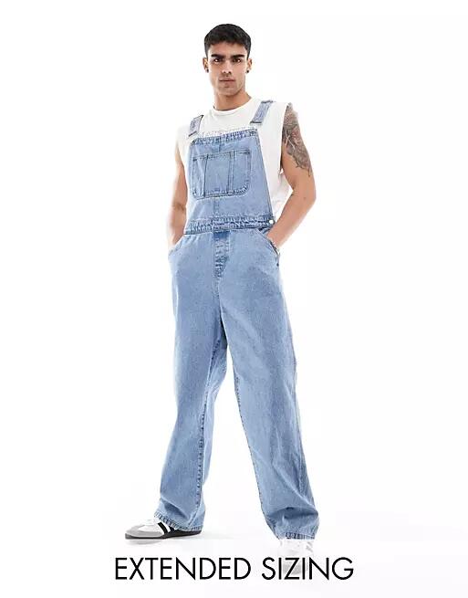 ASOS DESIGN oversized denim overalls in mid wash blue Cover