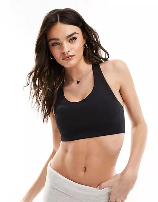 New Balance Active sports bra with cross back straps in black Cover