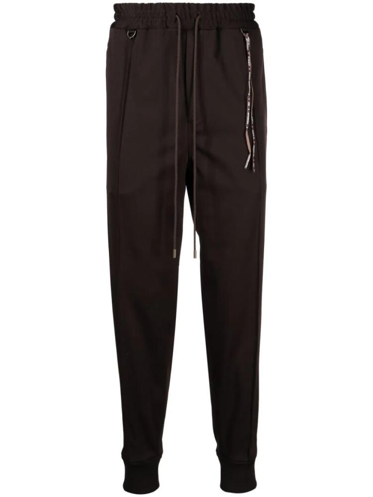 Mastermind World logo-jacquard tapered track pants - Brown Cover