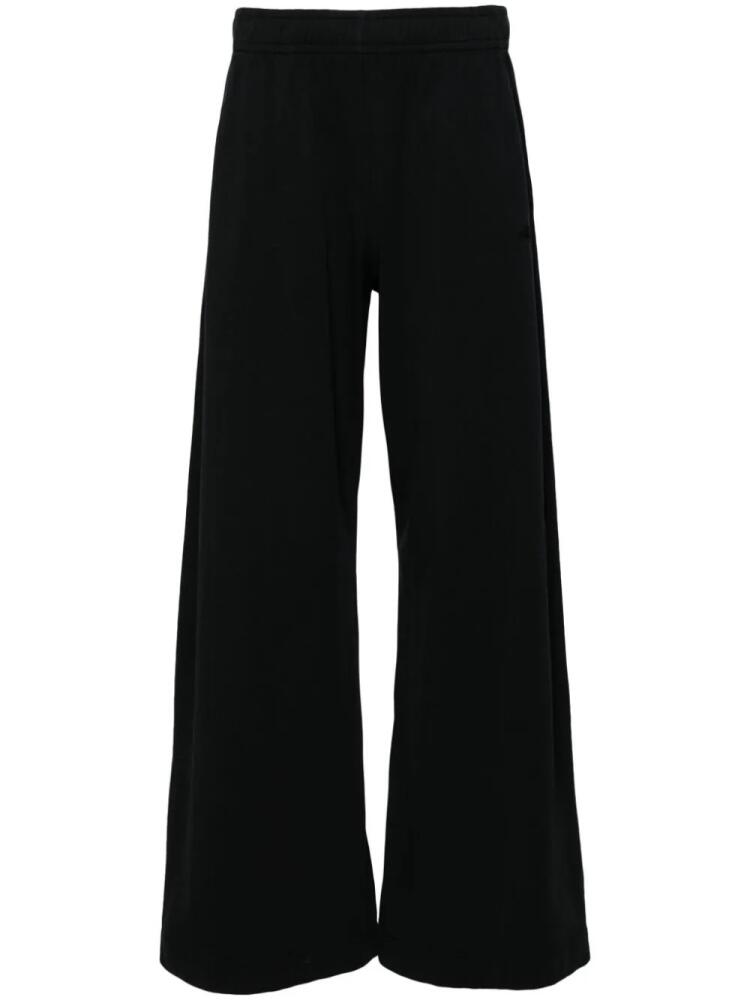 Nanushka logo-embroidered wide-leg trousers - Black Cover