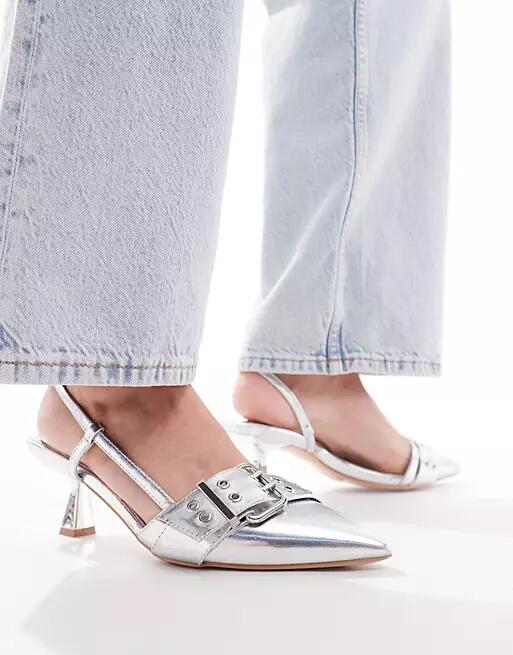 Simmi London Wide Fit Dala pointed kitten heel sling backs with grommet buckle detail in silver metallic Cover