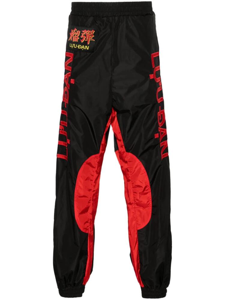 LỰU ĐẠN logo-patch track pants - Black Cover