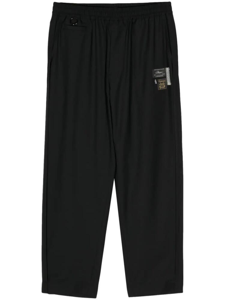 Undercover logo-appliqué straight trousers - Black Cover