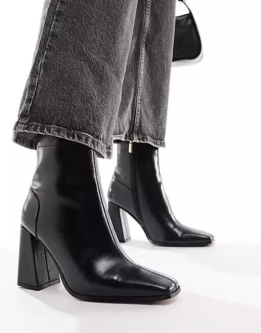 ASOS DESIGN Everest flared heel boots in black Cover