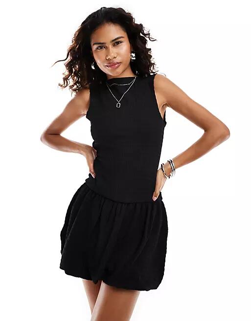 Reclaimed Vintage drop waist puffball mini dress in black Cover