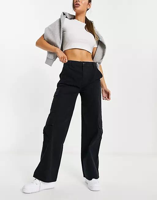 ASOS DESIGN oversized cargo pants with multi pocket in black Cover