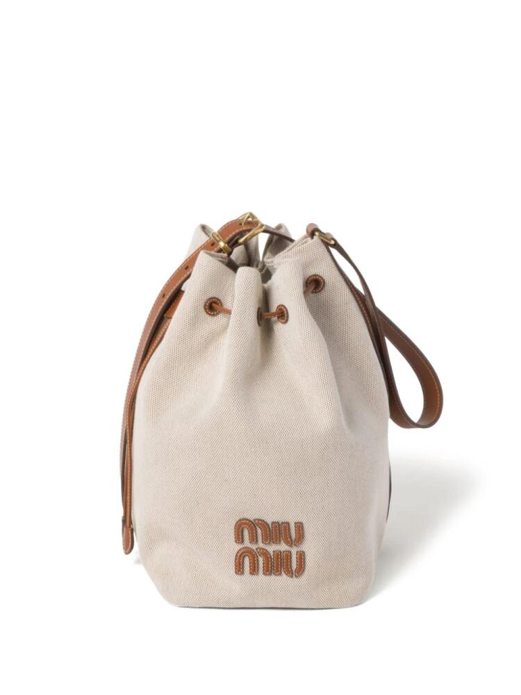 Miu Miu logo-lettering canvas bucket bag - Neutrals Cover