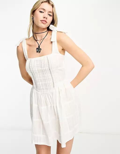 Reclaimed Vintage prairie mini dress with tie straps in white Cover