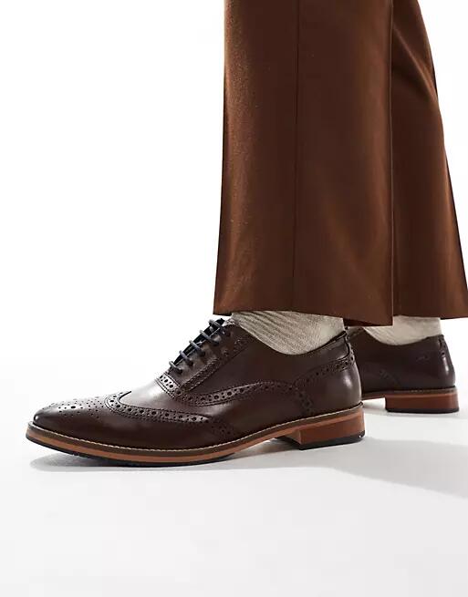 ASOS DESIGN brogue shoes in brown leather with natural sole and color details Cover