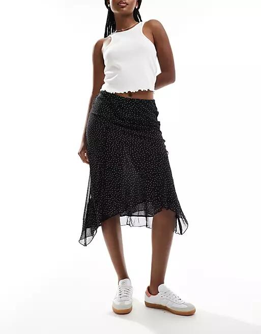 Mango asymmetric hem spot printed midi skirt in black Cover