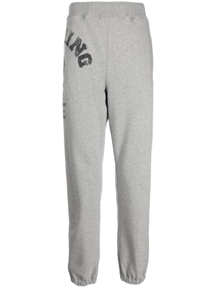 A BATHING APE® logo-print tapered track pants - Grey Cover