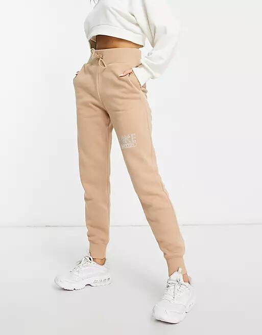 Nike Swoosh fleece joggers in brown Cover