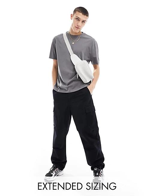 ASOS DESIGN baggy cargo pants in black Cover