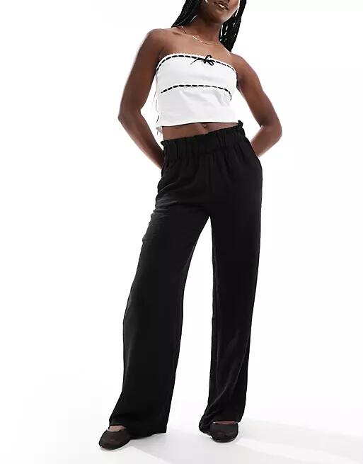 JDY high waisted wide leg pants with frill waistband in black Cover