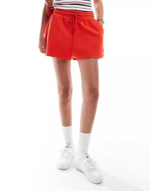 ASOS DESIGN sweat runner shorts in red Cover