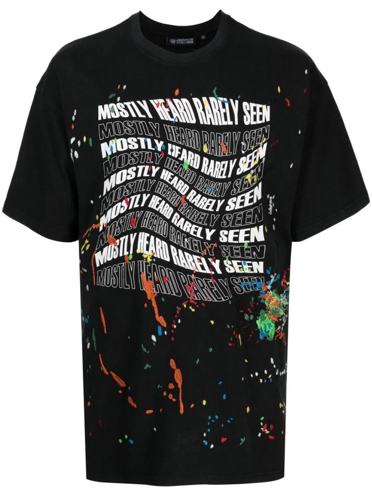 Mostly Heard Rarely Seen Warped-Logo paint-splatter T-shirt - Black Cover