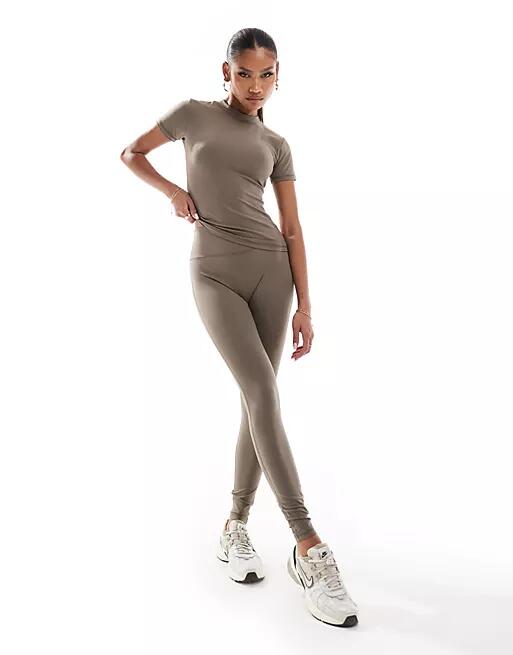 The Couture Club emblem soft touch leggings in brown Cover