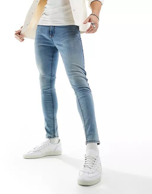 ASOS DESIGN spray on jeans with power stretch in tinted wash blue Cover