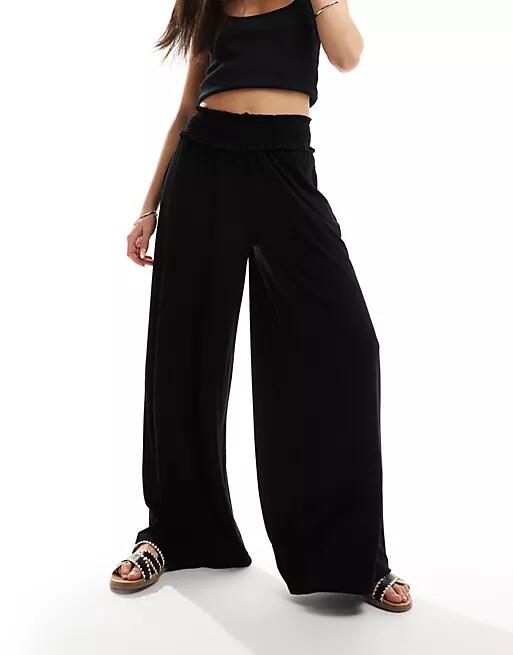 ASOS DESIGN shirred waist wide leg pants in black Cover