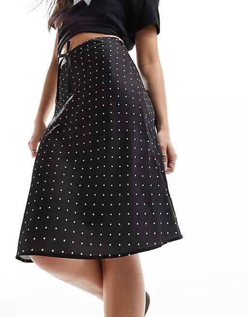 Monki satin a-line midi skirt with front bow detail in black and white polka dot Cover