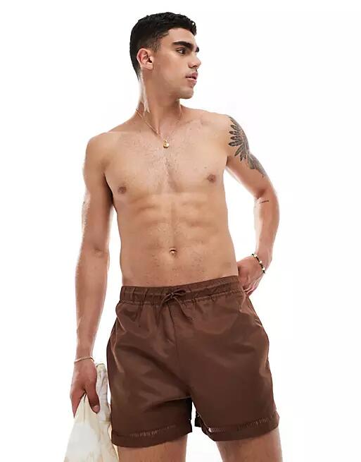 ASOS DESIGN swim shorts in short length with hem details in brown Cover