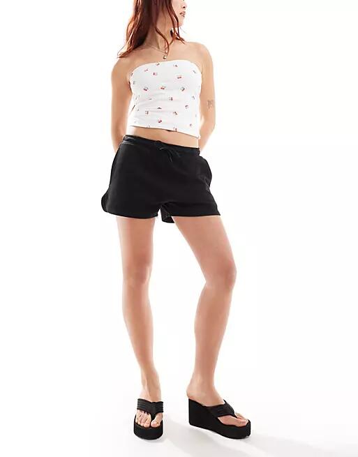 Monki heavy jersey shorts with curved hem in black Cover