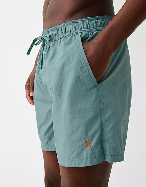 Bershka crinkle swim shorts in blue Cover