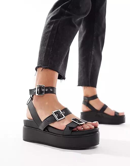 ASOS DESIGN Trombone chunky buckle detail flatforms in black Cover