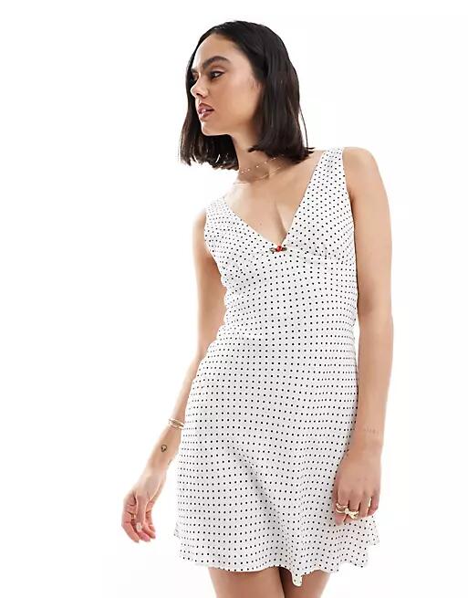 Bershka tie back mini dress in white and black spot Cover