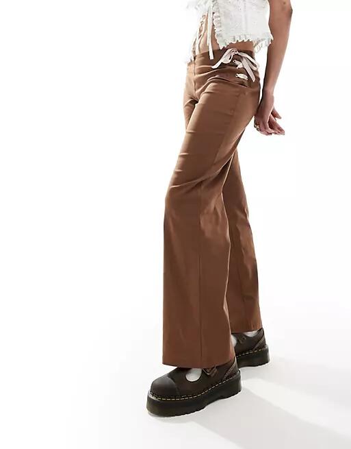 Reclaimed Vintage flare pants in brown with pink bows & ribbon Cover