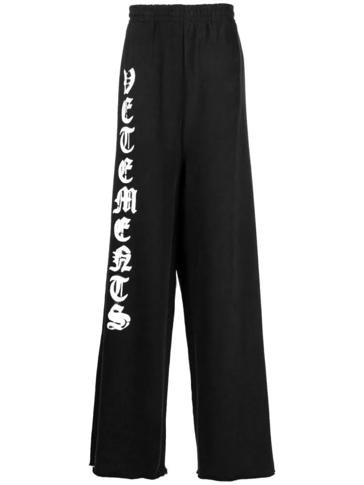 VETEMENTS logo-print cotton track pants - Black Cover