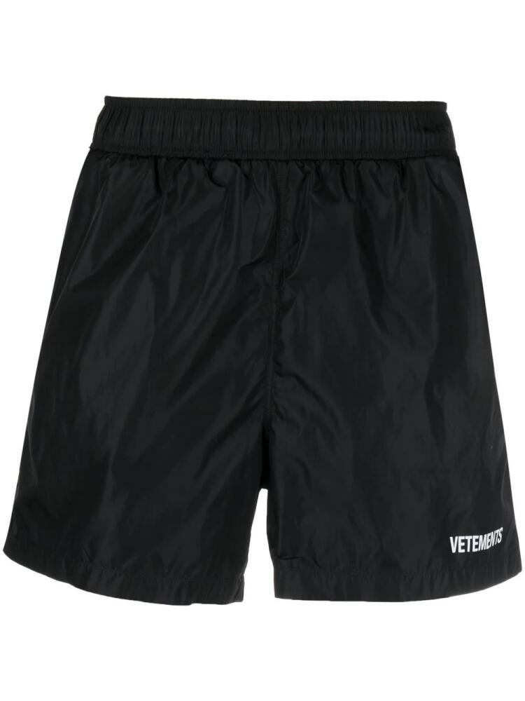 VETEMENTS logo-print track shorts - Black Cover