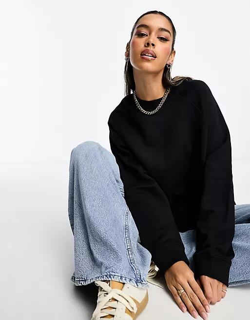 ASOS DESIGN oversized sweat with raglan detail in black Cover