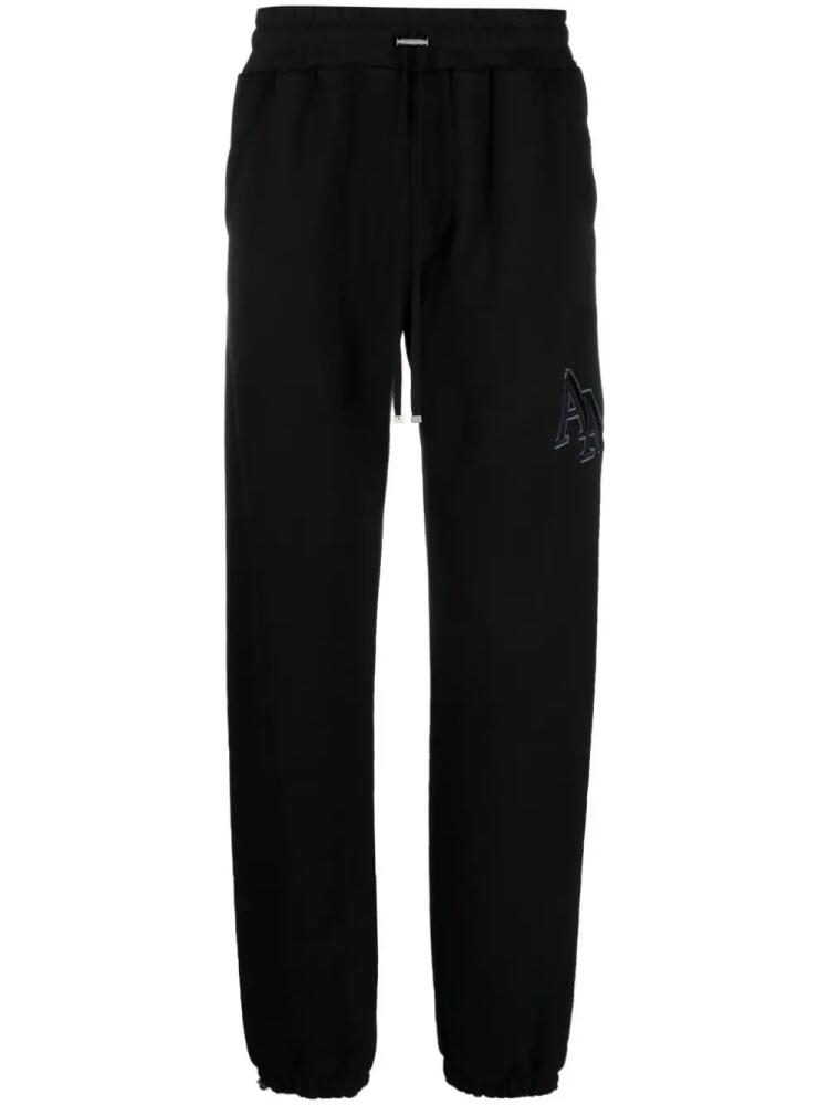 AMIRI Staggered logo-embroidered track pants - Black Cover