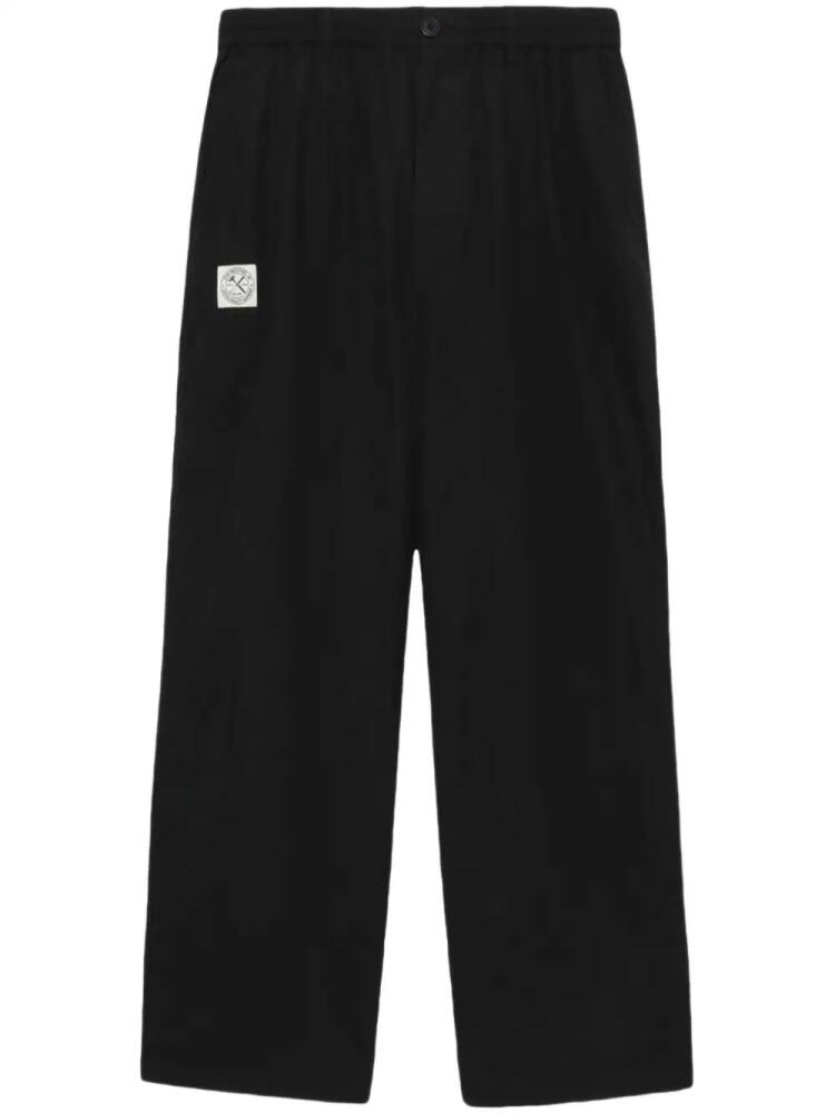 izzue logo-appliqué loose-fit trousers - Black Cover