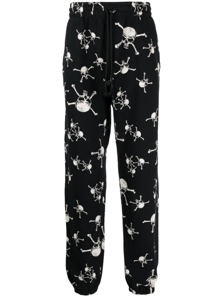 SAINT MXXXXXX skull-print cotton track pants - Black Cover