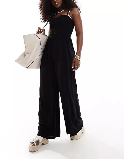 ASOS DESIGN shirred bandeau beach jumpsuit in black Cover