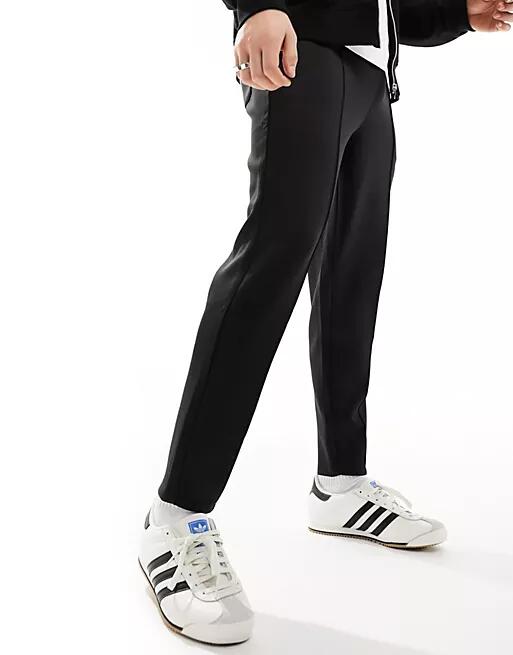 ASOS DESIGN tapered scuba sweatpants in black Cover