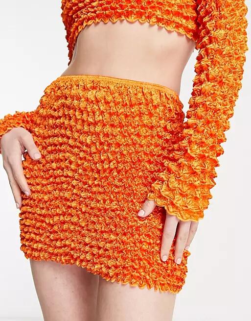 Annorlunda popcorn textured super mini skirt in bright orange - part of a set Cover